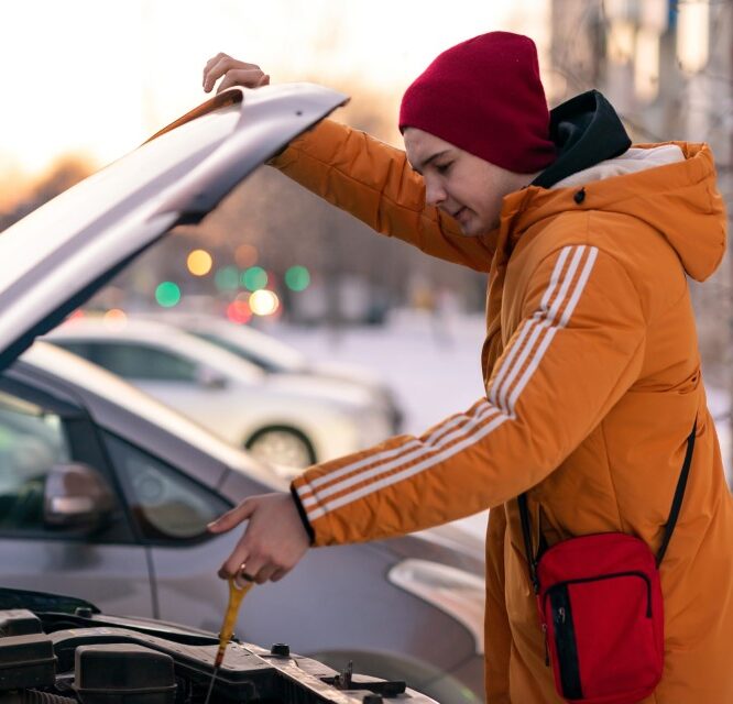 a-young-man-in-a-yellow-jacket-checks-the-oil-level-ways-start-diesel-engine-cold-heater-parts-power-performance